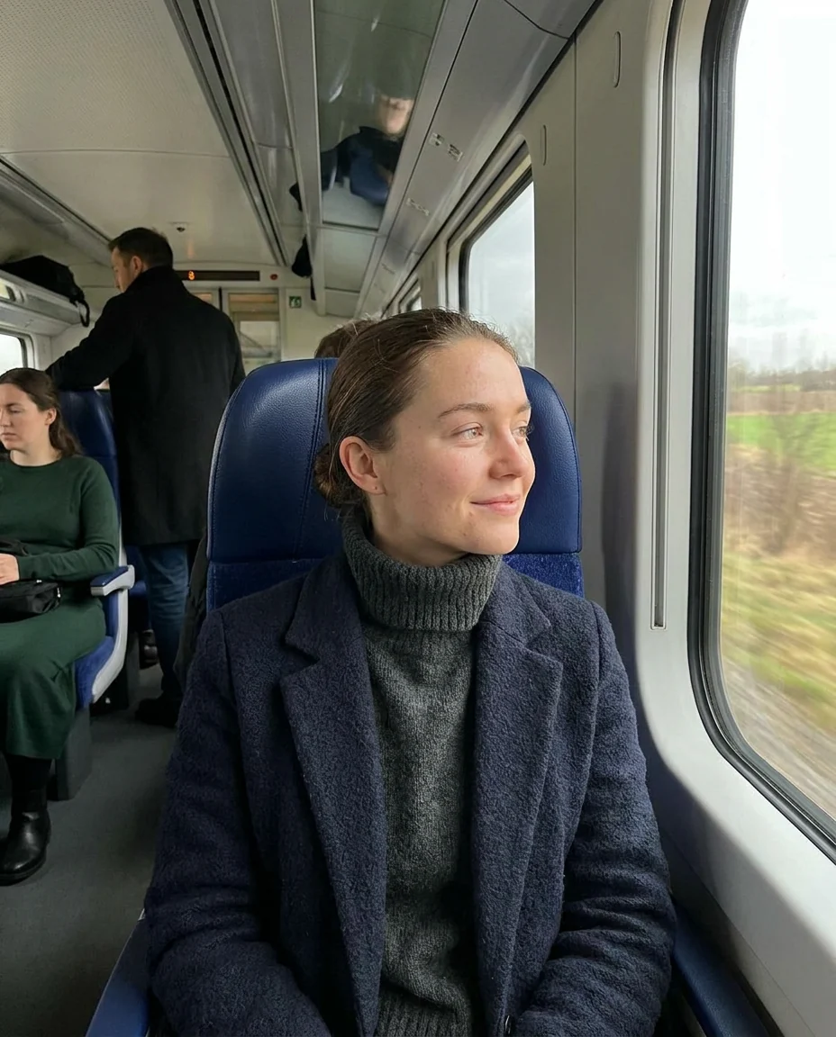 A woman on a train looking out of the window