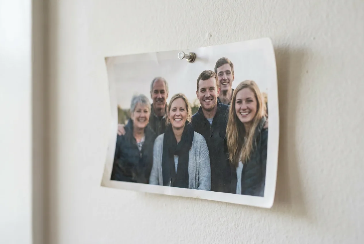 A printed group photo pinned to a wall